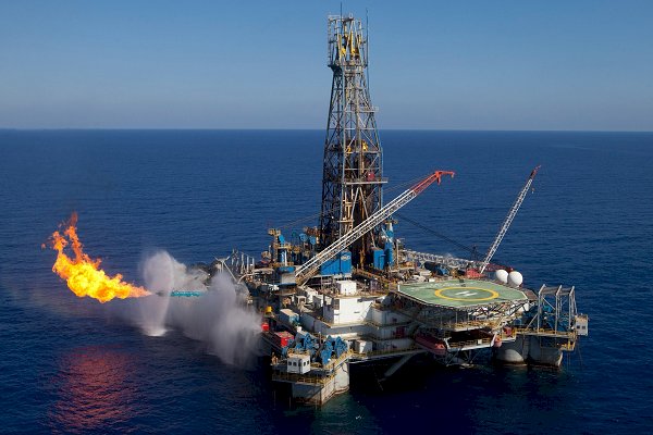 Oil falls to nearly $56 a barrel, its lowest in a year